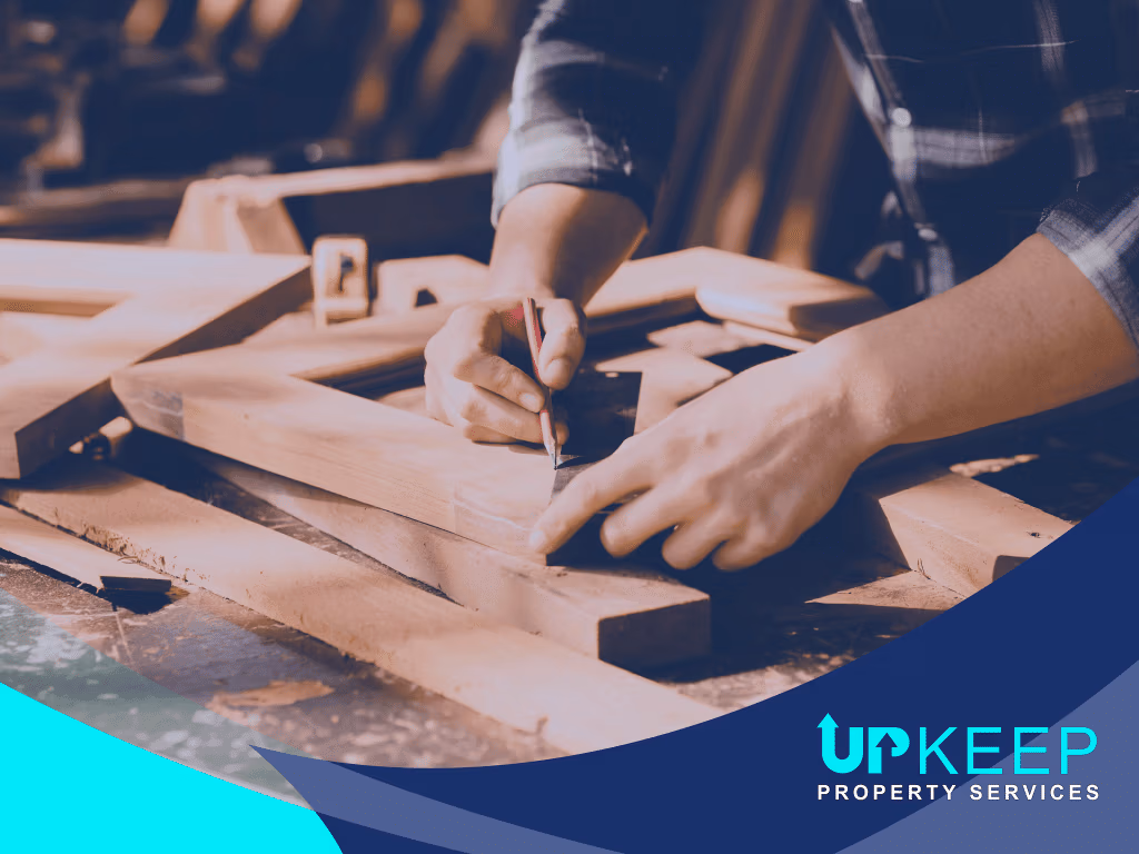 Carpenter measuring and marking timber on a workbench, showcasing UpKeep Property Services construction and carpentry work