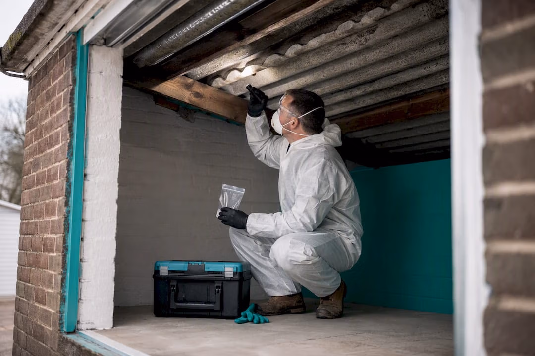 Surveyor inspecting older garage roof sheets